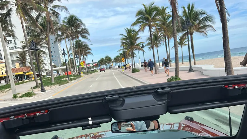 Driving a topless Jeep along the beach road