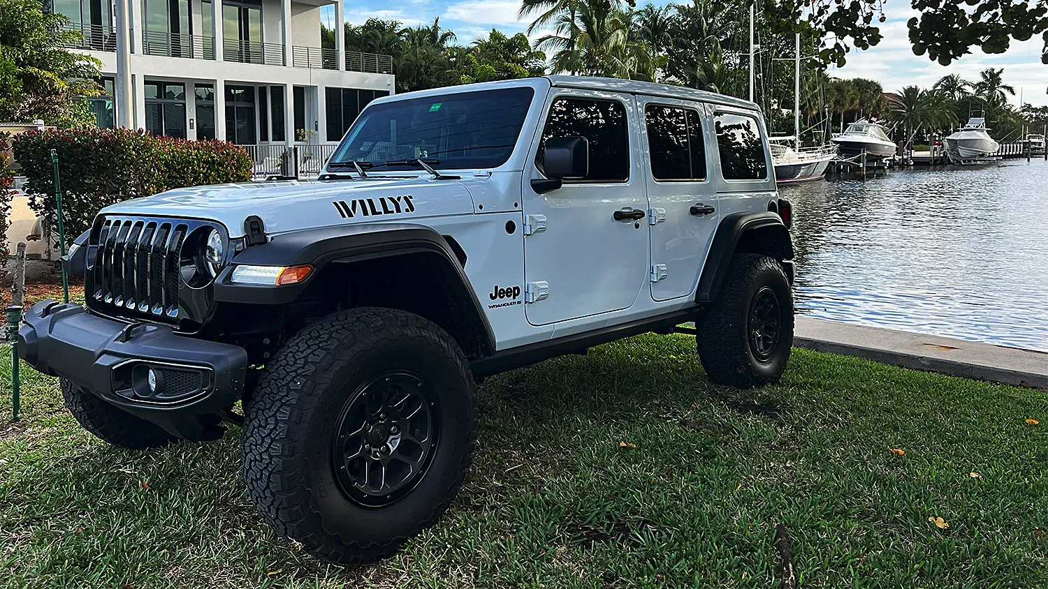 White Jeep Willys delivered to a hotel entrance